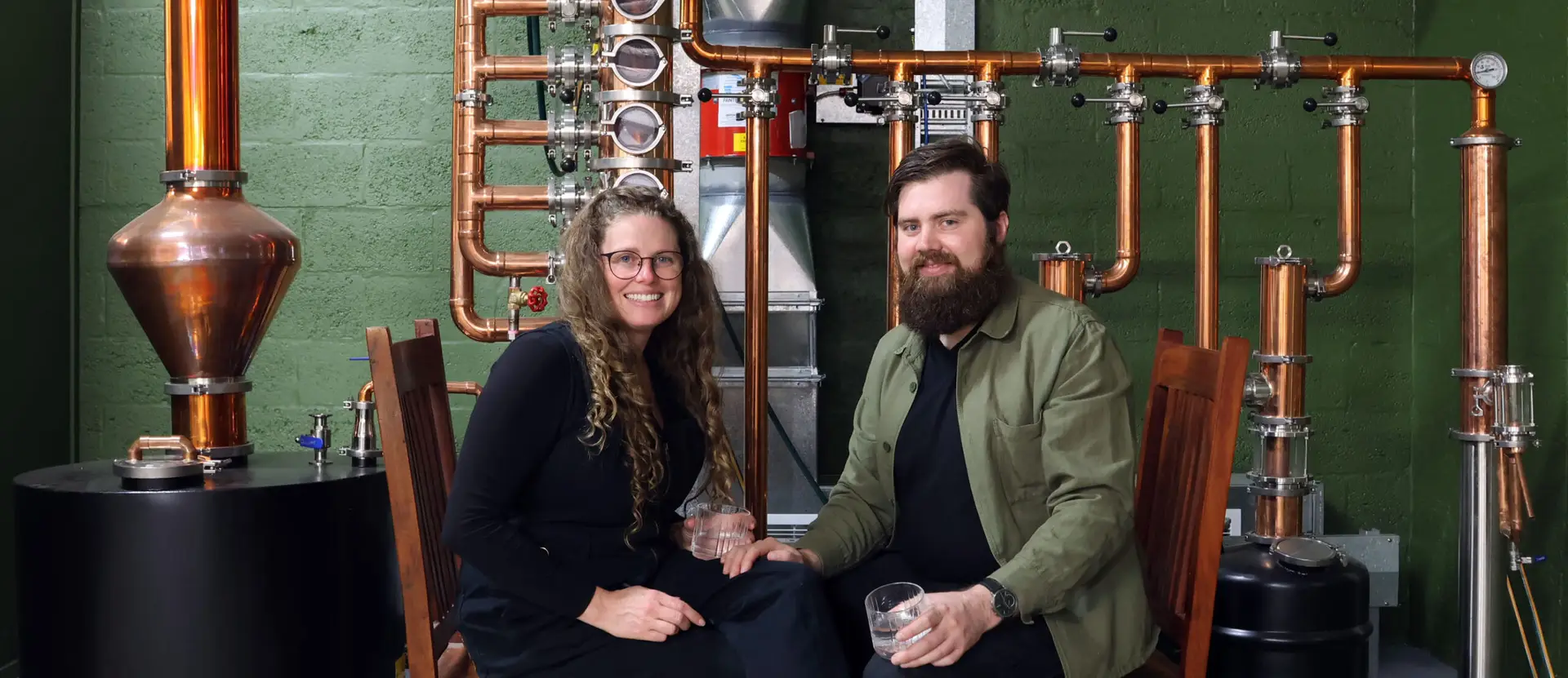 Renee & David sitting in front of the still.